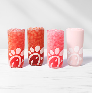 Person dipping a nugget into Chick-fil-A® Sauce with a package of Chick-fil-A® Nuggets in the background