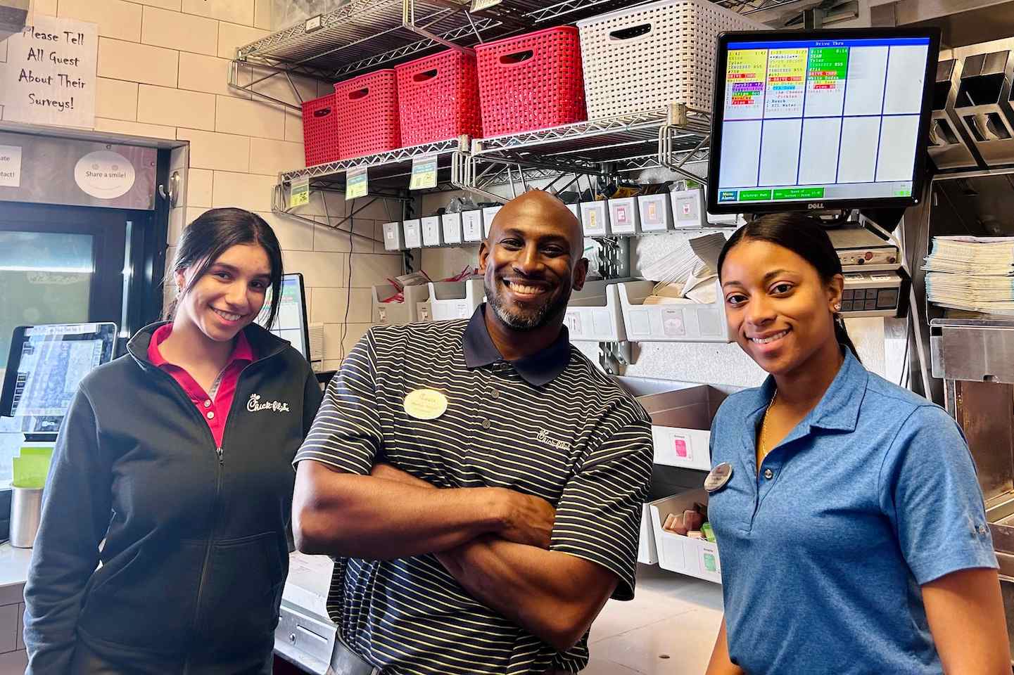  Operator Marlon standing with two Team Members