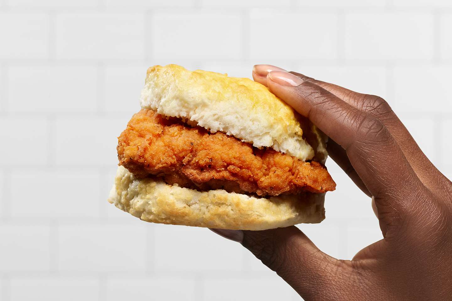 Customer holding the Chick-fil-A Spicy Chicken Biscuit