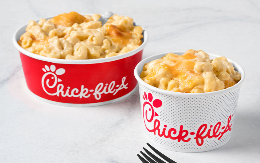 A large and small Mac & Cheese sitting next to each other on a white counter