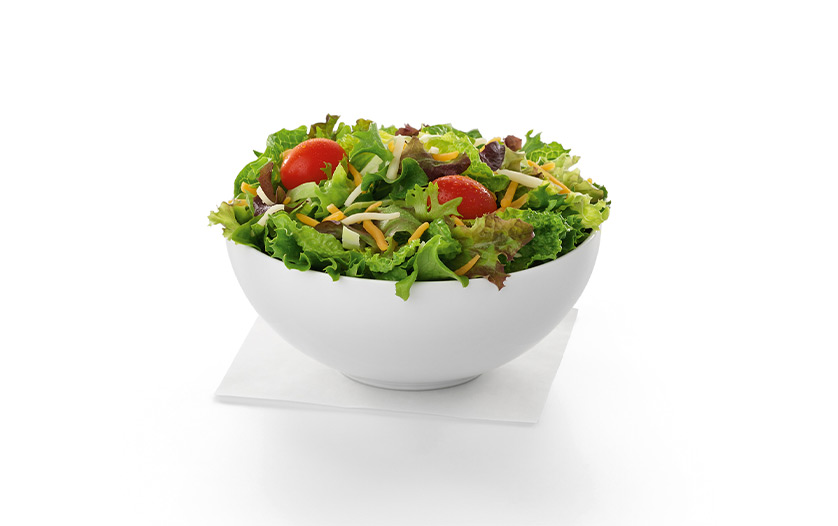  A white bowl of our Side Salad sitting on a white napkin