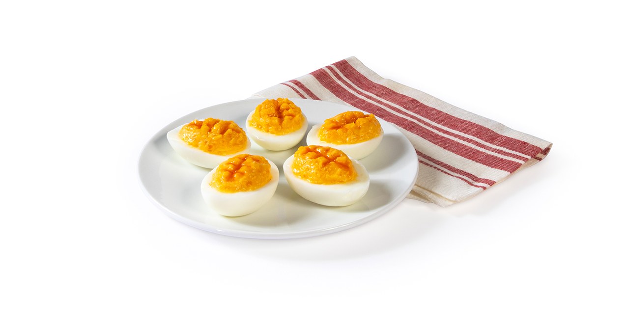Five Polynesian Footballs on a white plate with a red and white cloth napkin 