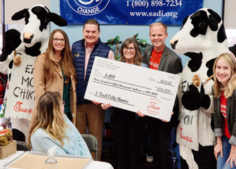 SADI representatives receiving an S. Truett Cathy True Inspiration Award for $350,000, flanked on both sides by Chick-fil-A representatives and cow mascots.