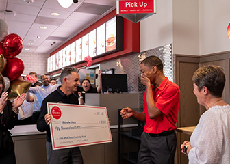 Team Member Malcolm Jones receives $50,000 from Chick-fil-A's Eddie White Servant Leadership scholarship at Chick-fil-A 95 & 264 in Wilson, N.C. 