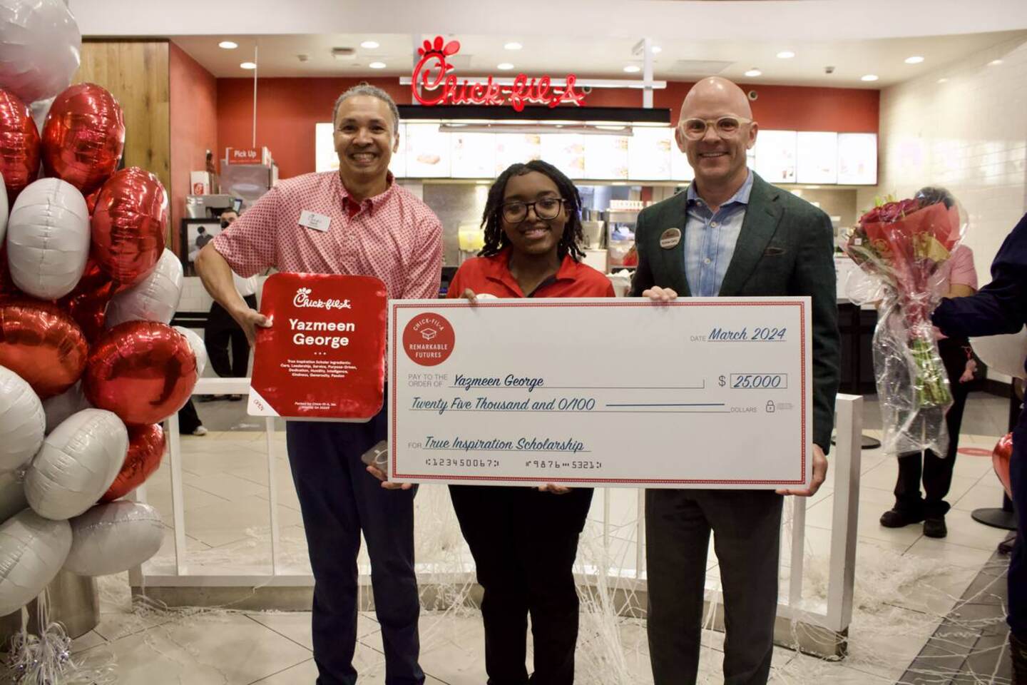Andrew T. Cathy surprising Chick-fil-A Kenwood Towne Centre Team Member Yazmeen George with a $25,000 scholarship.