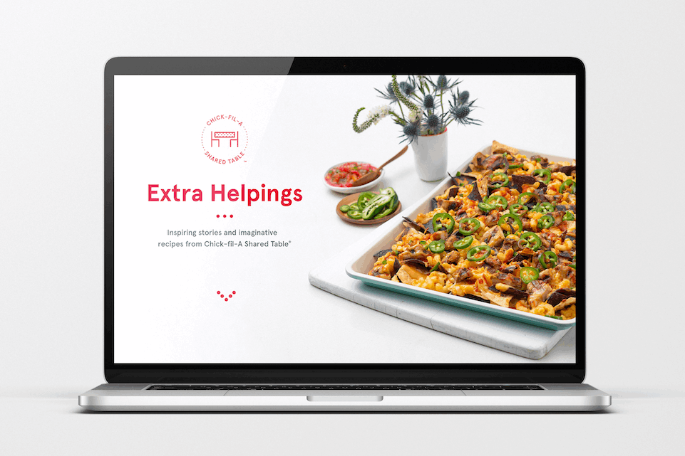 A laptop showing the front cover of the new Chick-fil-A Shared Table program digital cookbook, "Extra Helpings."