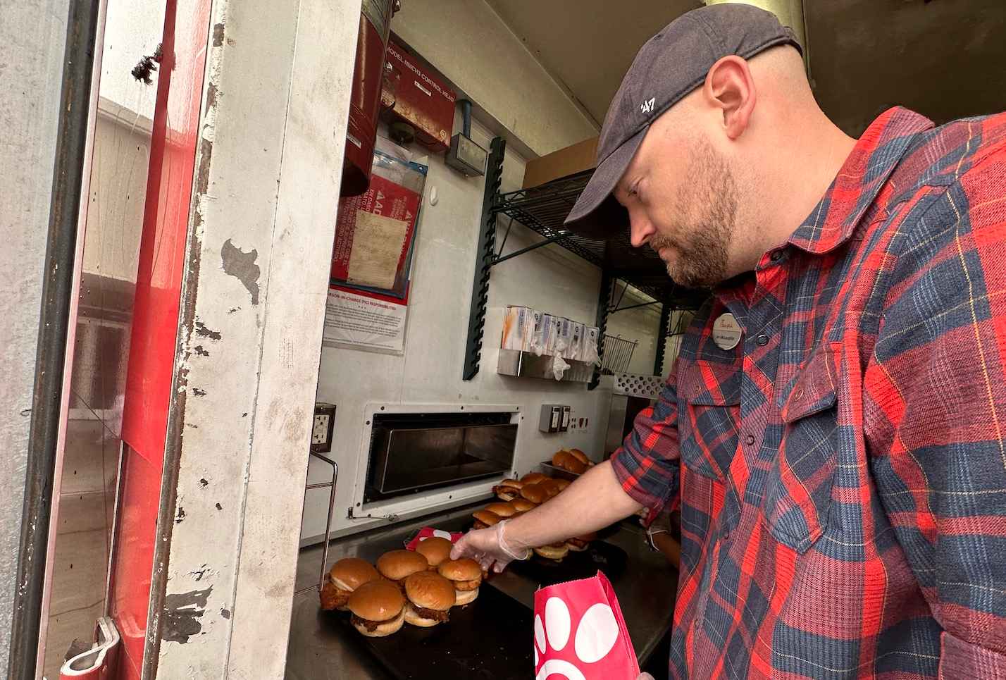 A Chick-fil-A Team Member prepares chicken sandwiches that will be served to the community. 