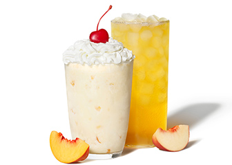 The Chick-fil-A Peach Milkshake and White Peach Sunjoy next to a peach slice on a white background.