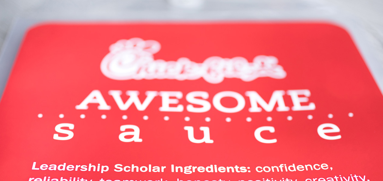 A red sign resembling a Chick-fil-A sauce packet reading "Chick-fil-A Awesome Sauce".