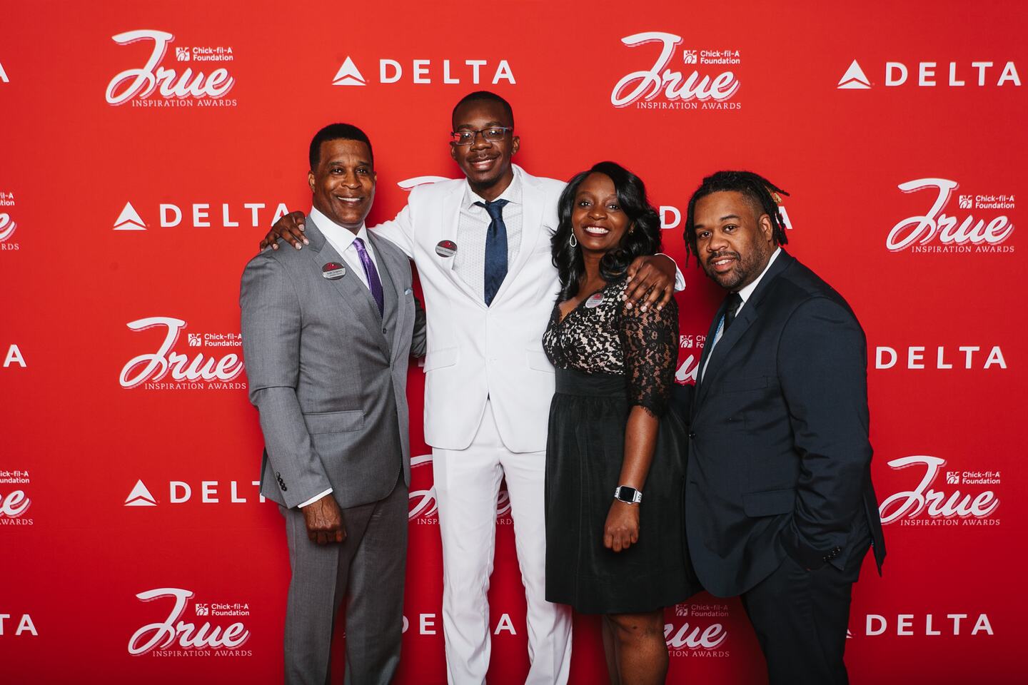 Representatives from Mentoring to Manhood on a red background in Hyattsville, MD.