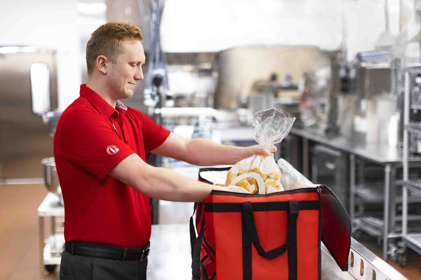 A Chick-fil-A employee packaging biscuits to be sent to the Shared Table Program.