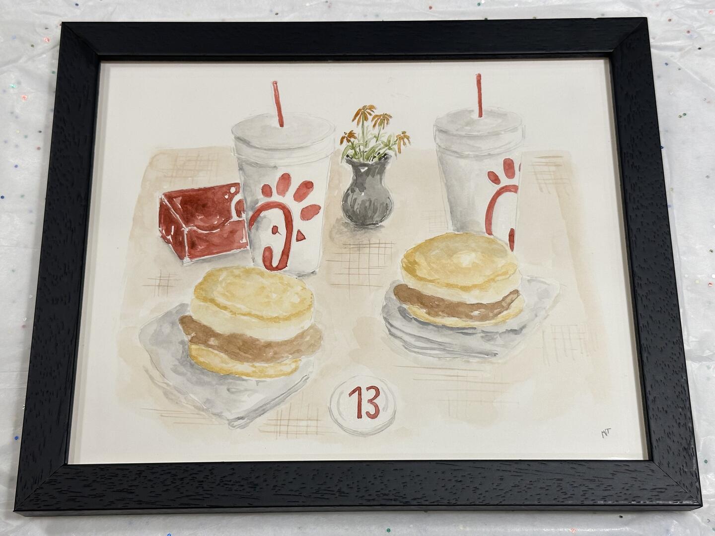 A commemorative painting of a Chick-fil-A biscuit breakfast at booth 13 at Chick-fil-A Sienna Crossing in Missouri City, Texas.