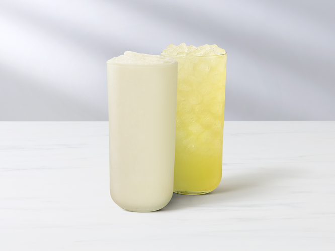 Key Lime Lemonade and Key Lime Frosted Lemonade glasses sitting on a table.