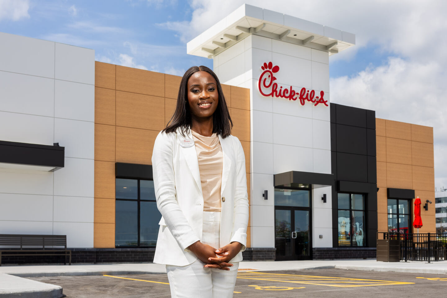 Chick-fil-A Owner-Operator Ibukun Olubiyi posing for a photo in front of her new restaurant in Ottawa, Ontario, Canada.