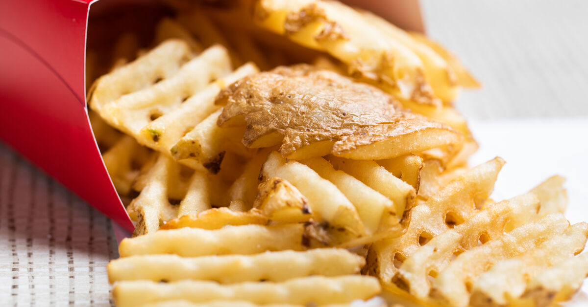 Chick-fil-A Waffle Potato Fries on a white table cloth in a red box.