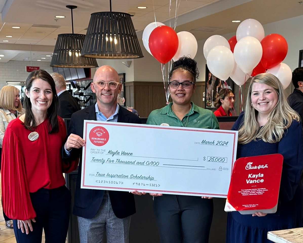 True Inspiration Scholarship winner Kayla Vance poses with her check.