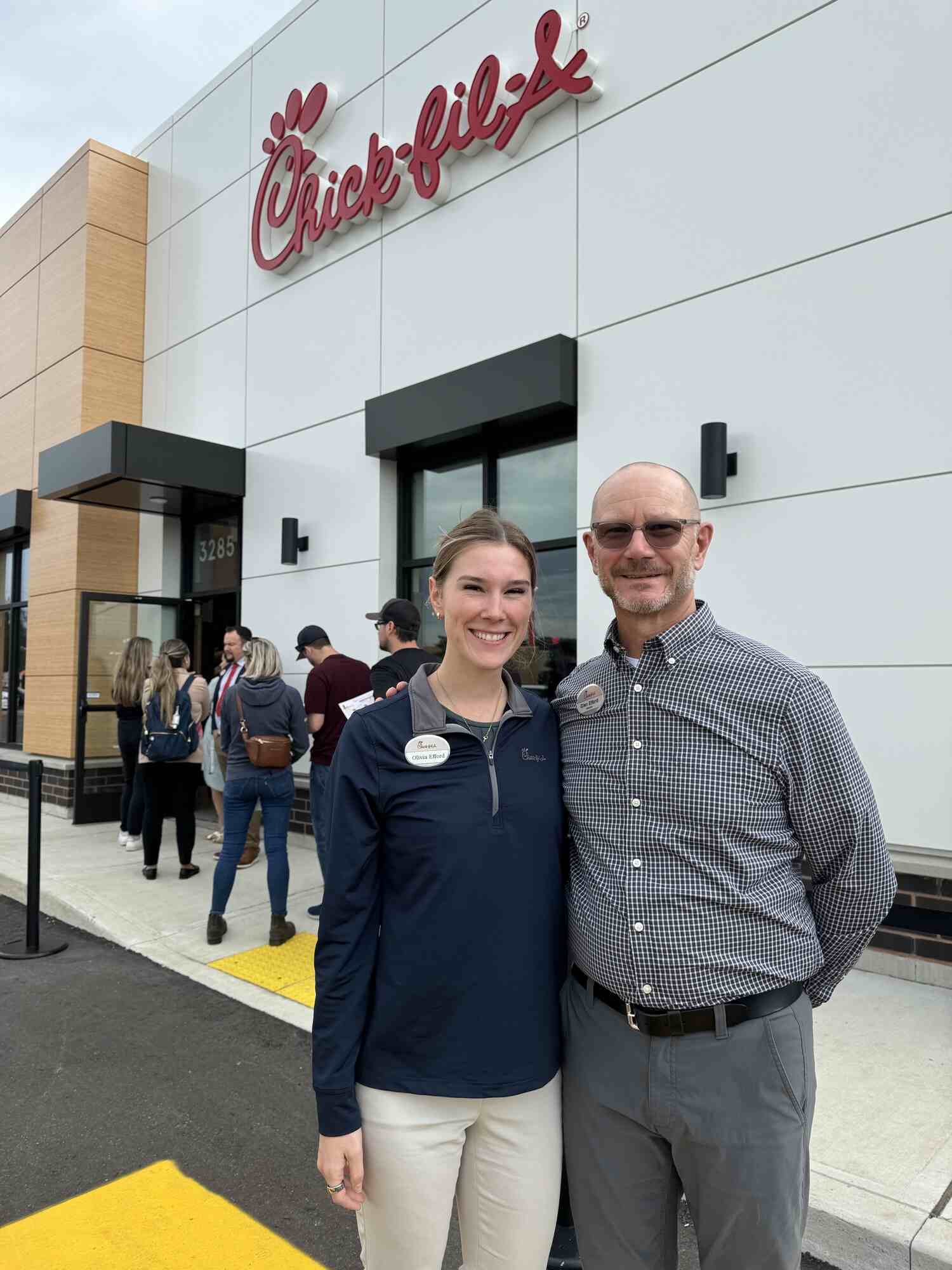 Owner-Operators Glen and Olivia Efford posing for a photo in front of her Chick-fil-A in Kitchener, Ontario, Canada.
