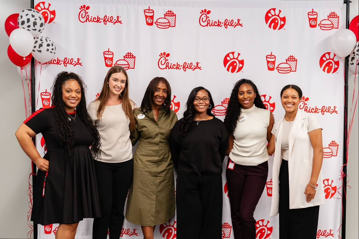Six people from the Morris Brown Leadership Development Program standing in front of a Chick-fil-A background. 