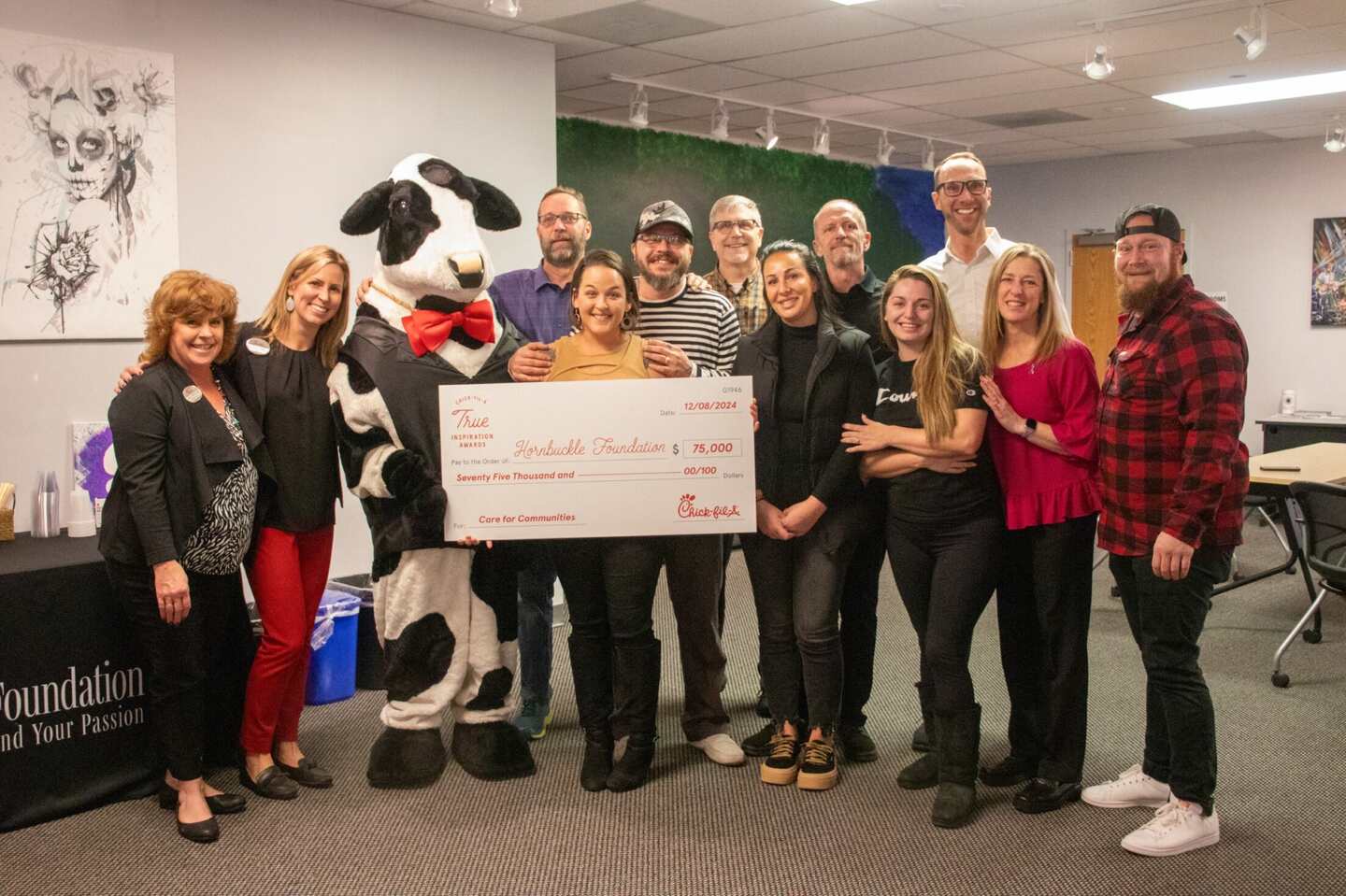 Hornbuckle Foundation of Littleton, Colorado holding a True Inspiration Award check with the Chick-fil-A Cow. 