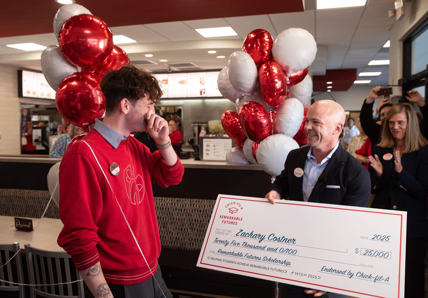 Chick-fil-A CEO Dan Cathy awarding a scholarship to Team Member Zachary Costner.