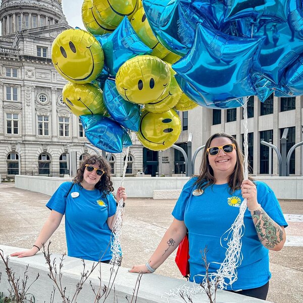 Team Members handing out balloons outside the courthouse.