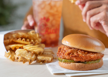 Closeup of Chick-fil-A® Spicy Chicken Sandwich Meal with Waffle Potato Fries™ and an Iced Tea