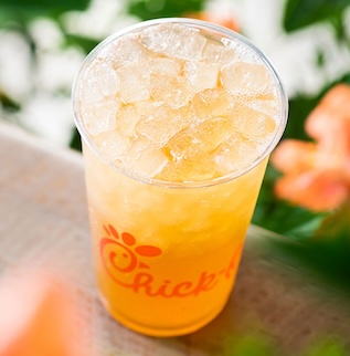 Sunjoy™ beverage sitting on a table in front of flowers