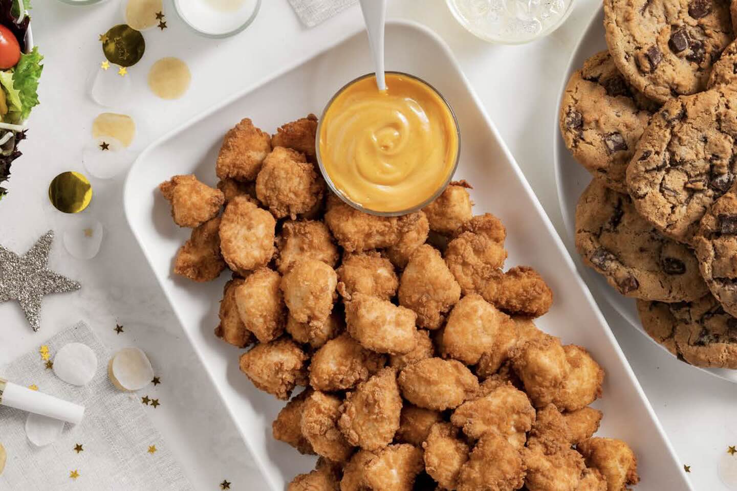 Chick-fil-A® Nuggets Tray, cookies and salad on a table with decorations