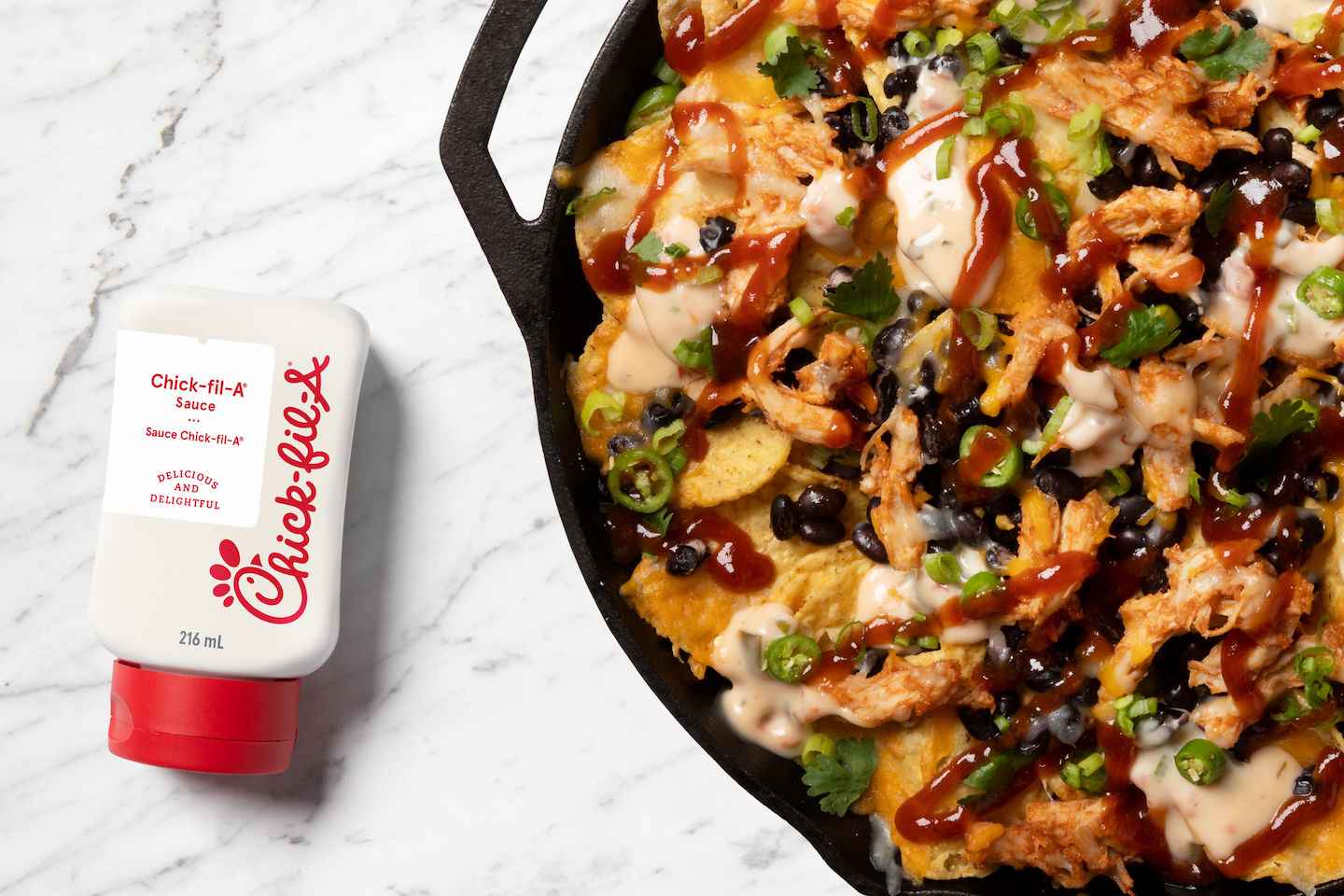  A shot of a bottle of 8 oz Chick-fil-A Sauce® with Nachos.