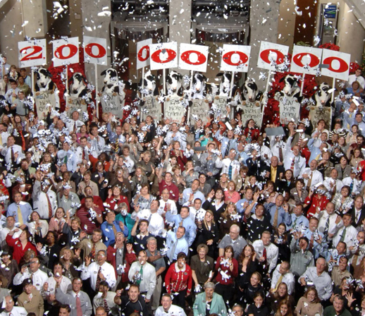 A large group of Chic-fil-A operators and stafff celebrating 2 billion in sales