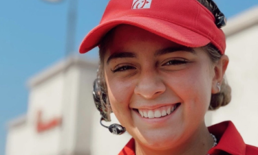 Chick-fil-A Team Member wearing headset and red visor and smiling