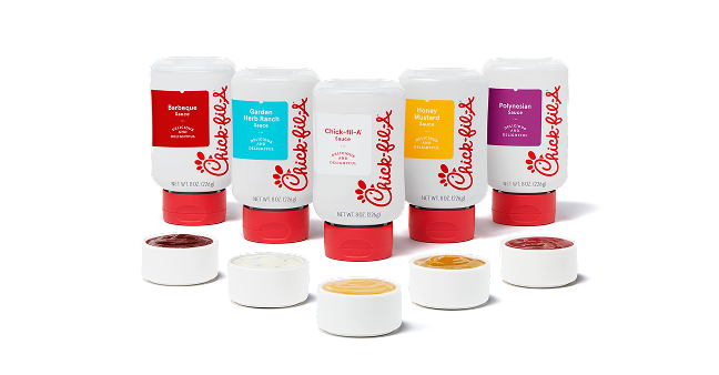 A bottle of Barbeque Sauce, Garden Herb Ranch Sauce, Chick-fil-A® Sauce and Polynesian Sauce sitting behind small ramekins of each sauce 