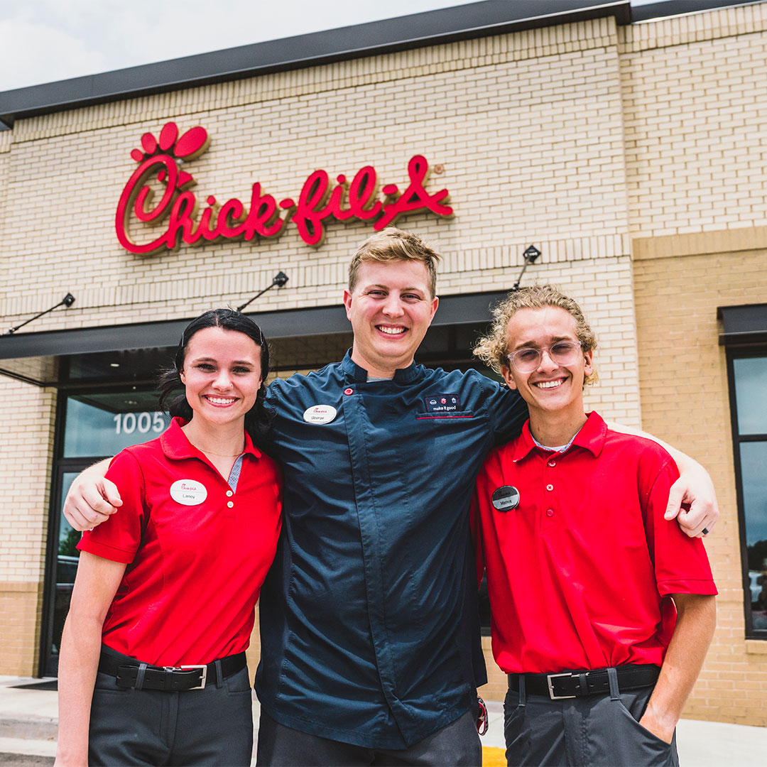 Three Team Members standing together outside a Chick-fil-A Restaurant