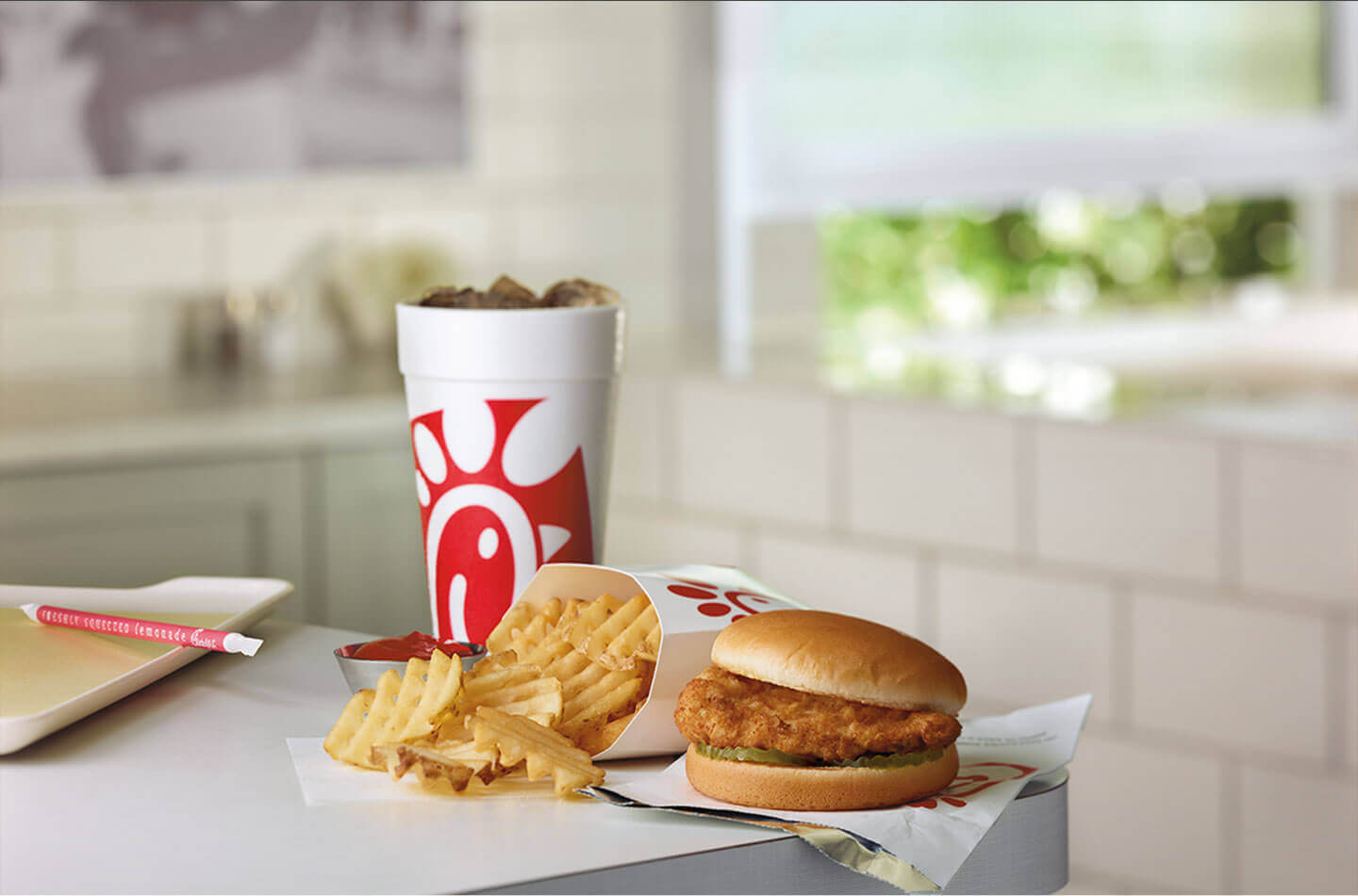 Chicken sandwich, waffle fries and a soda