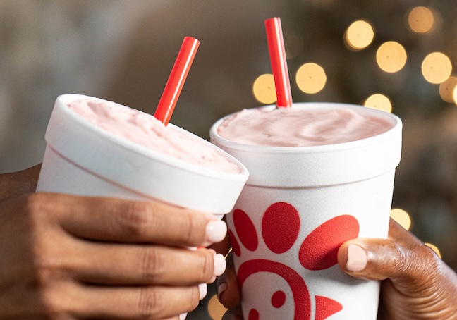 Two people holding a Peppermint Chip Milkshake