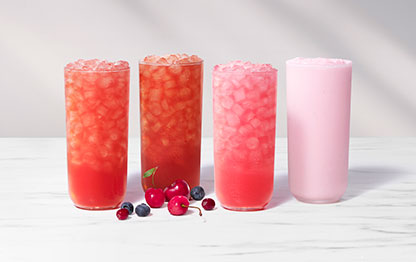 Cherry Berry Sunjoy®, Iced Tea, Lemonade and Frosted Lemonade on a gray background with cherries, blueberries and cranberries on a marble background