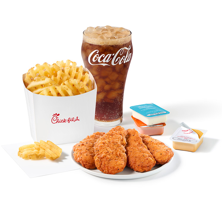 A plate of 4-count Chick-fil-A Chick-n-Strips® next to packets of Garden Herb Ranch Sauce, Zesty Buffalo Sauce and Chick-fil-A® Sauce with Waffle Fries and a Coca-Cola Zero