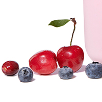 Closeup photo of cherries, cranberries and blueberries on a white background