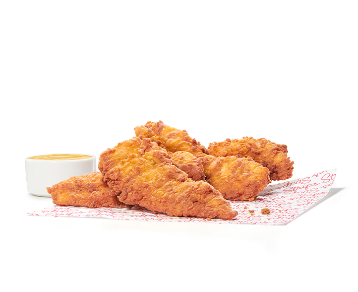 Chick-fil-A Chick-n-Strips® on printed parchment paper with dipping sauce 