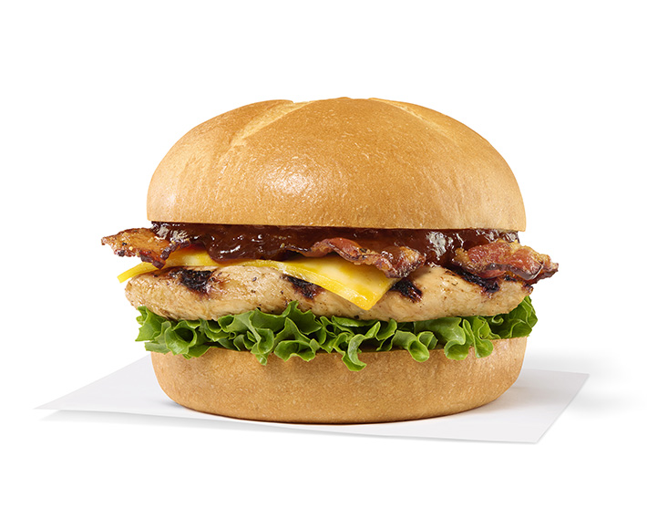 Smokehouse BBQ Bacon Sandwich with Grilled filet sitting on a napkin on a white background