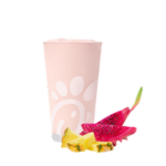 A glass of a Pineapple Dragonfruit Frosted Lemonade on a white background