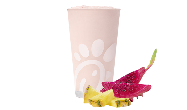 A glass of a Pineapple Dragonfruit Frosted Lemonade on a white background
