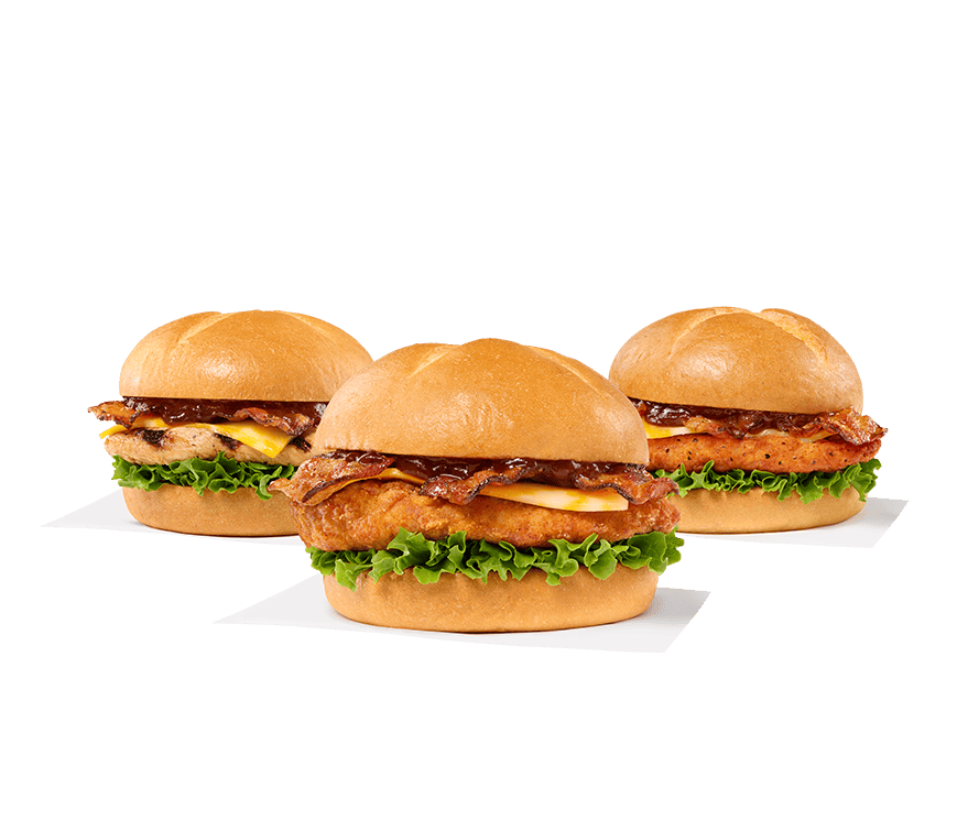 Smokehouse BBQ Bacon Sandwich with Grilled filet, Smokehouse BBQ Bacon Sandwich with Original filet, Smokehouse BBQ Bacon Sandwich with Spicy filet sitting next to a red and white napkin on a white background