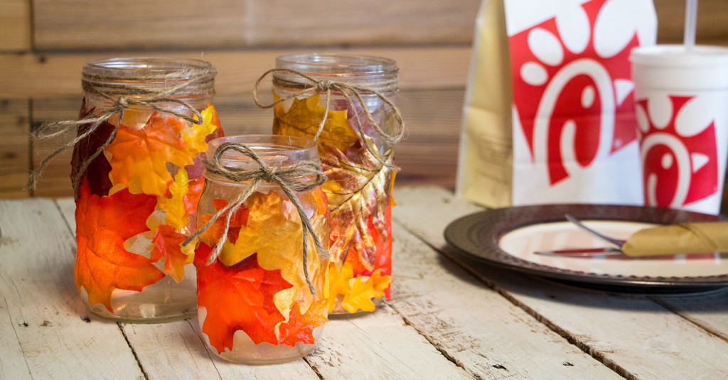 A display of leaf decorated mason jars
