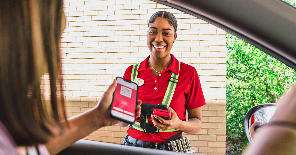 CFA One Scanning-Main Image: Chick-fil-A® Team Member stands outside of customers car, ready to scan their app