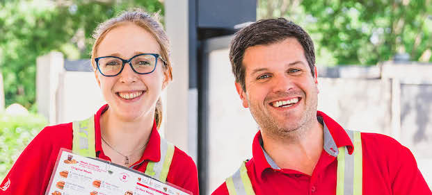 Two Chick-fil-A Team Members standing outside and smiling